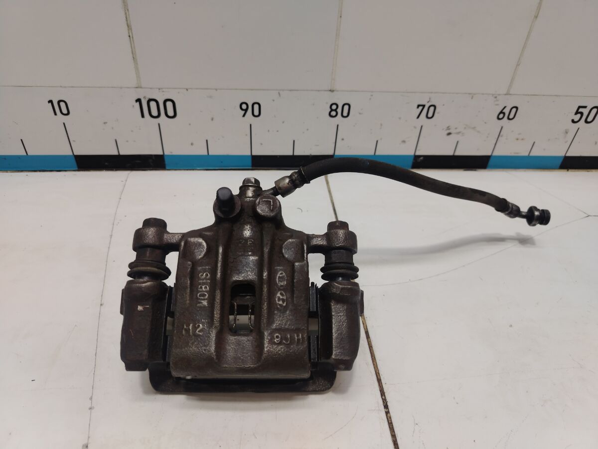 Суппорт тормозной задний левый Kia Optima (JF) IV рестайлинг (2018– н.в.)